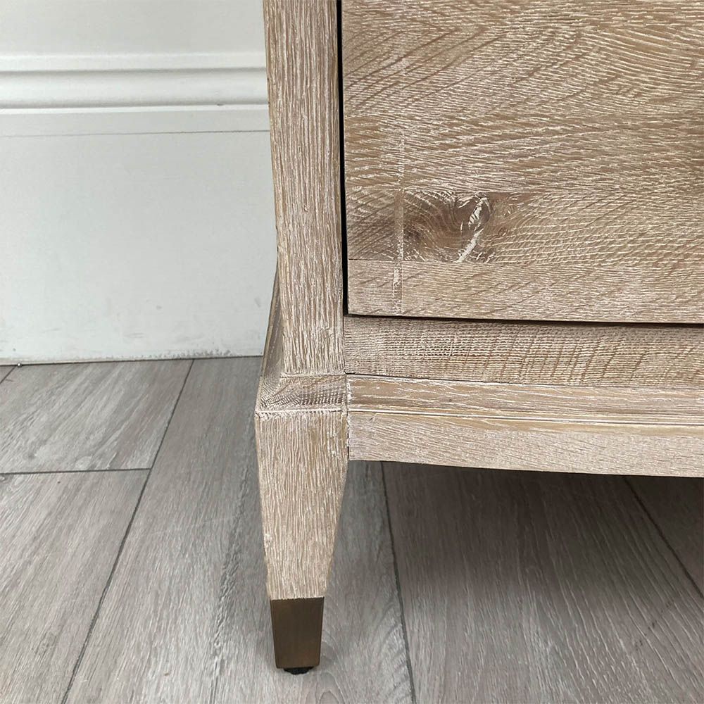 A stunning natural whitewash oak three-drawer chest with brass detailsils