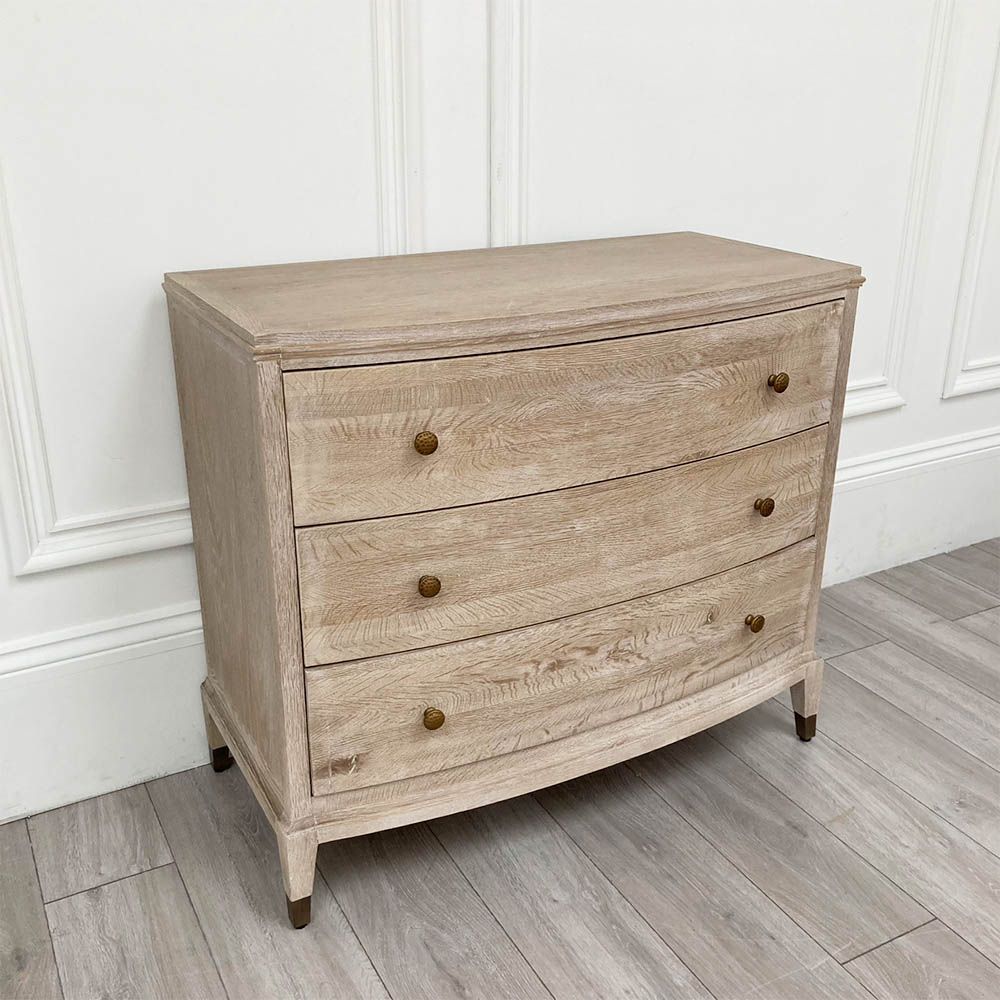A stunning natural whitewash oak three-drawer chest with brass details