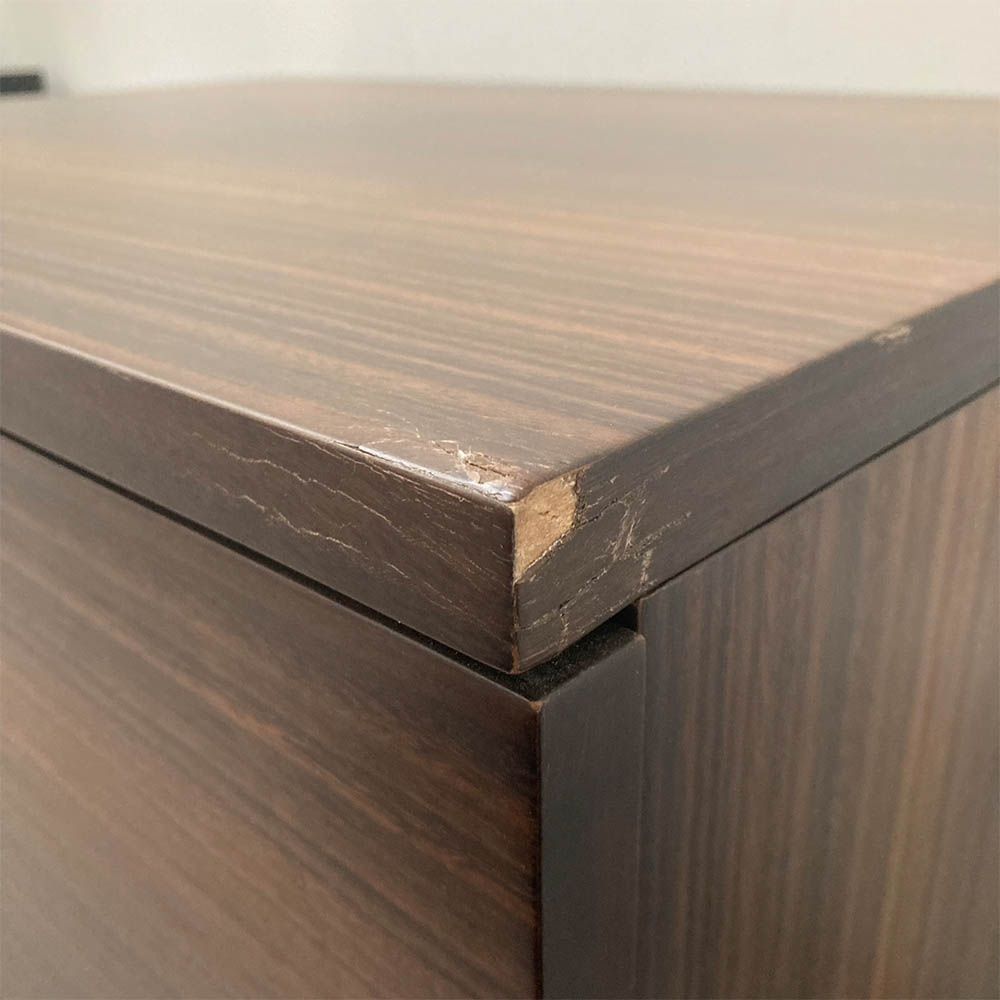 Minor chip and cracks on front right of the bedside table
