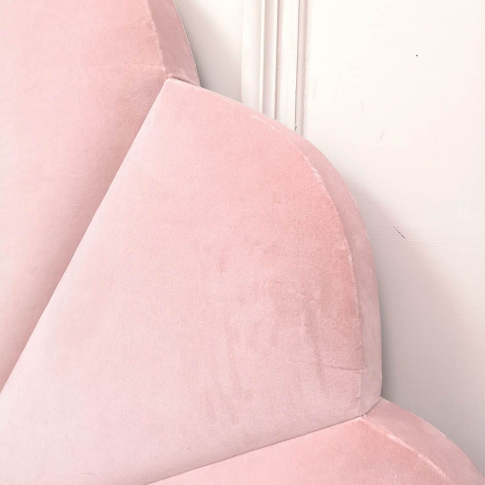 Gorgeous, statement kingsize bed with rounded, fluted headboard and blossom coloured upholstery