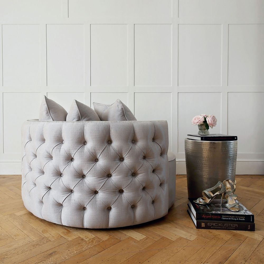 Luxurious swivel love seat with deep buttoning and chrome studding