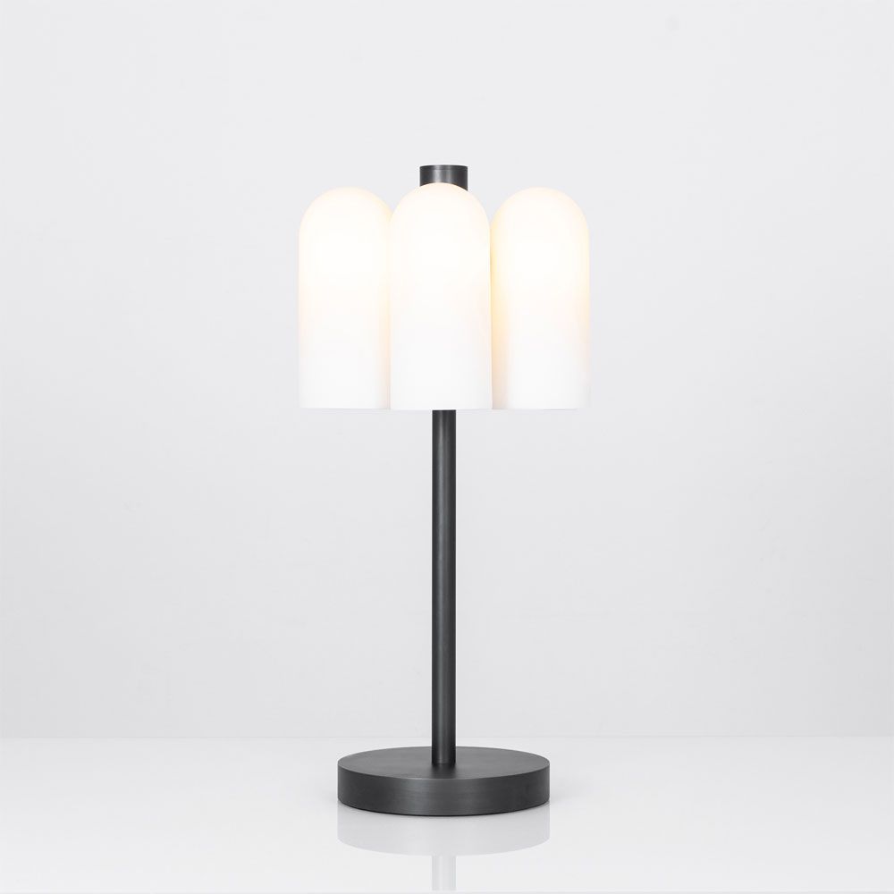 A bold black gunmetal LED table lamp with six triplex opal glass lampshades