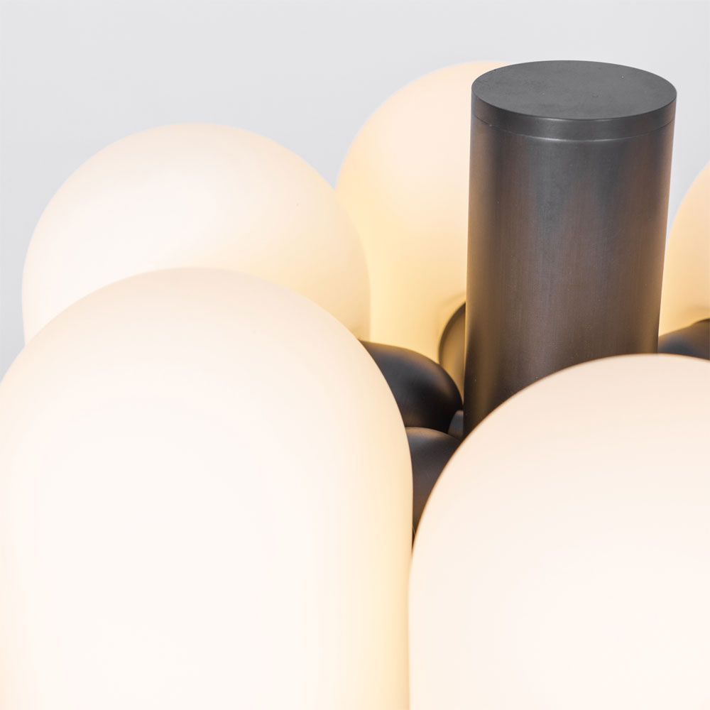 A bold black gunmetal LED table lamp with six triplex opal glass lampshades