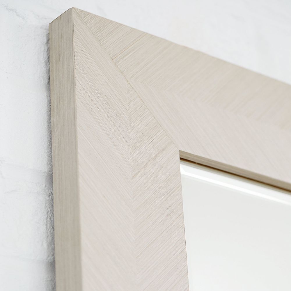 A modern and versatile wall mirror with a wooden frame that can be hung vertically or horizontally 