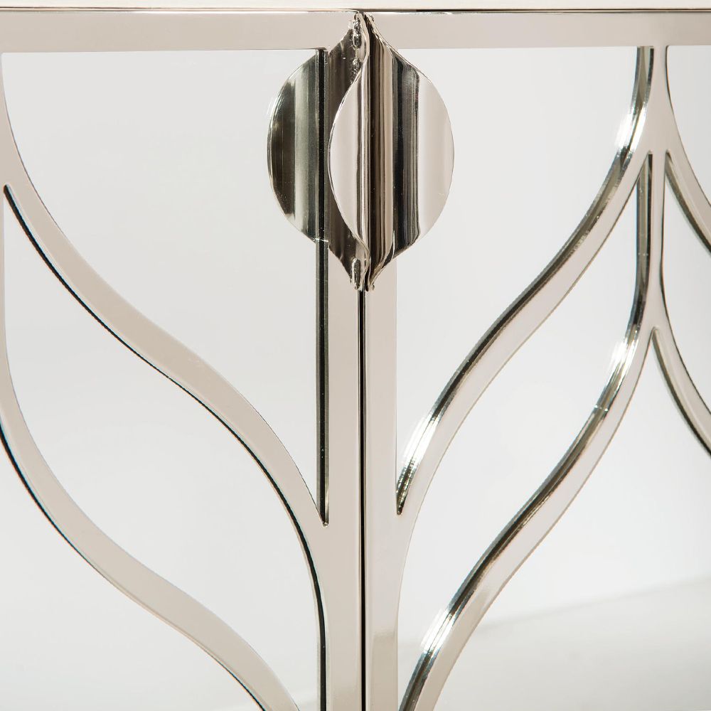 A dazzling buffet with three mirrored glass doors featuring decorative stainless steel overlays and an abundance of internal storage 
