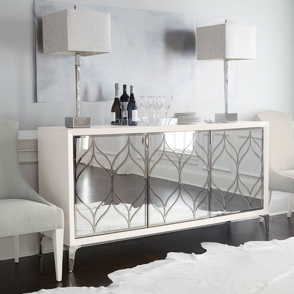 A dazzling buffet with three mirrored glass doors featuring decorative stainless steel overlays and an abundance of internal storage 