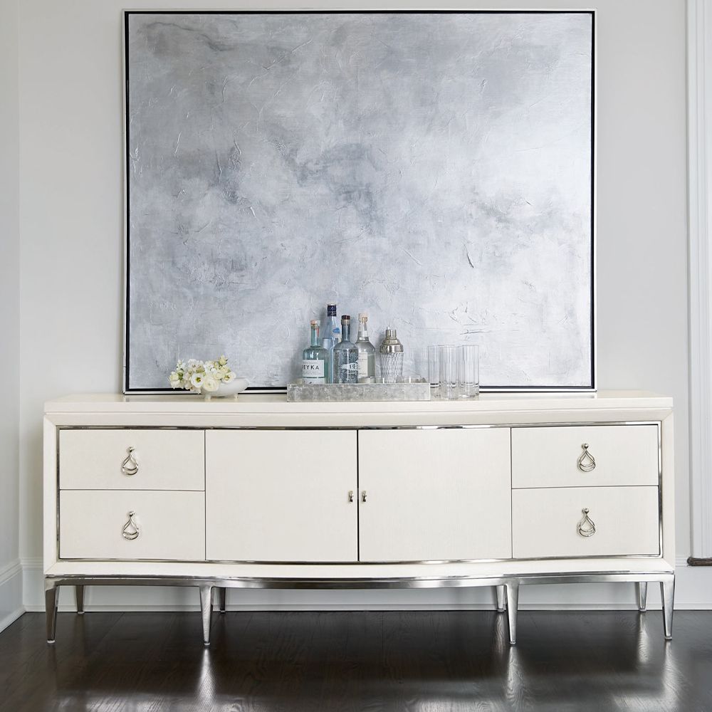 A contemporary entertainment unit with polished stainless steel accents, four drawers, two doors and internal shelving
