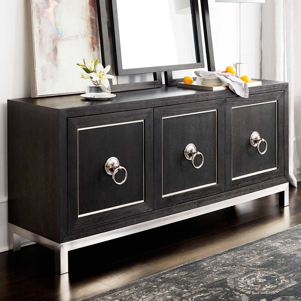 An elegant three door sideboard with a dark brown wooden finish and stylish stainless steel accents