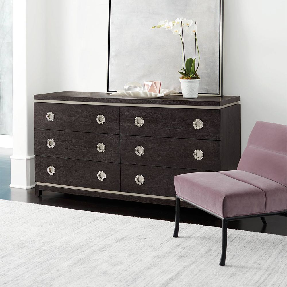 A stunning dark brown wooden dresser with six drawers and stylish stainless steel accents