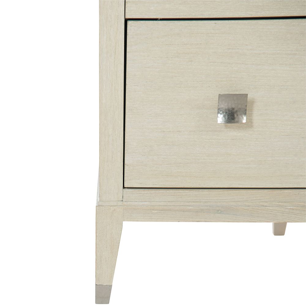 A gorgeous dresser from Bernhardt with a natural finish, tarnished nickel accents and nine drawers