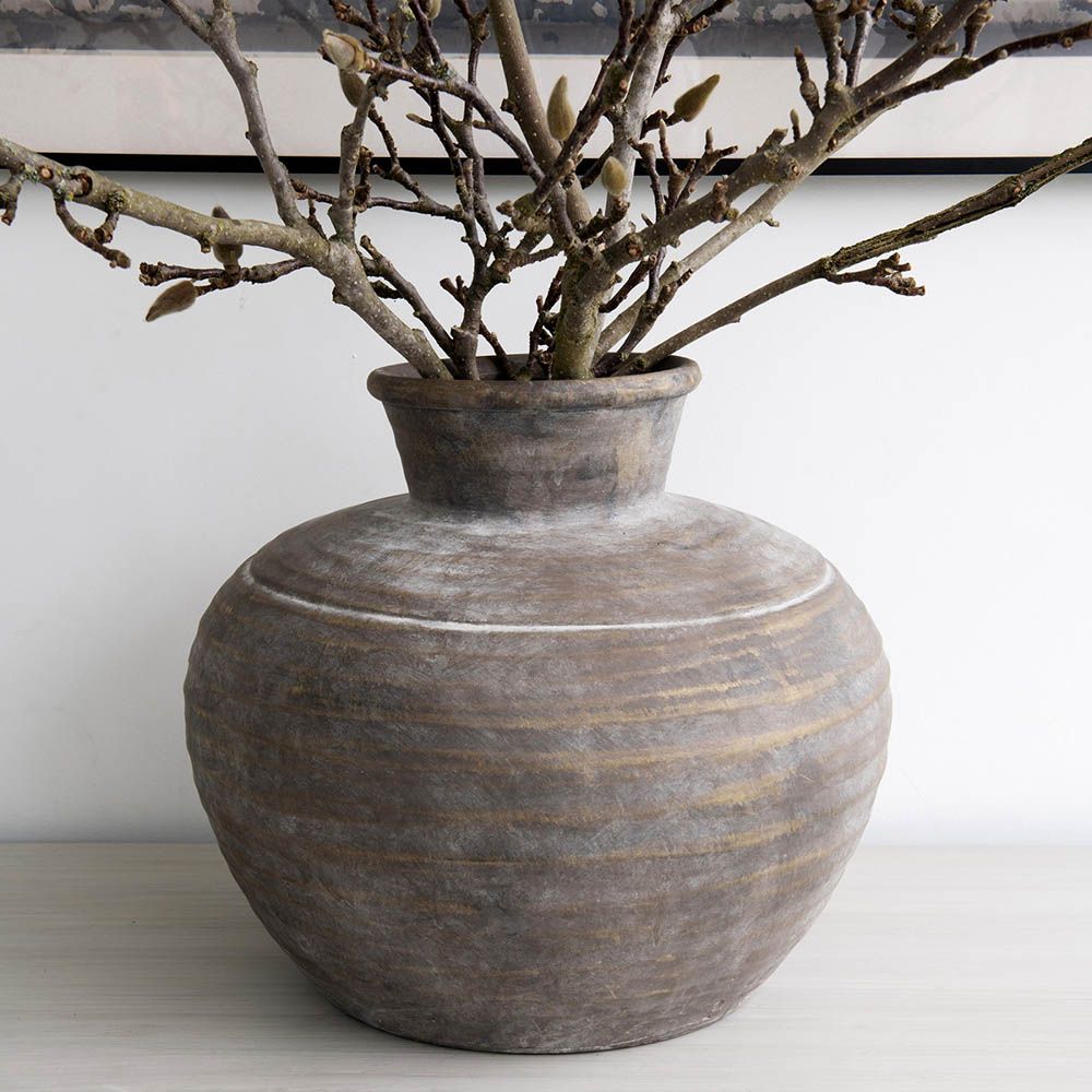Elegant rounded brown vase with a natural finish