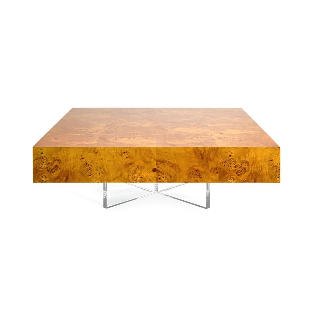 A modern natural wood table with an acrylic cross base and nickel accents 
