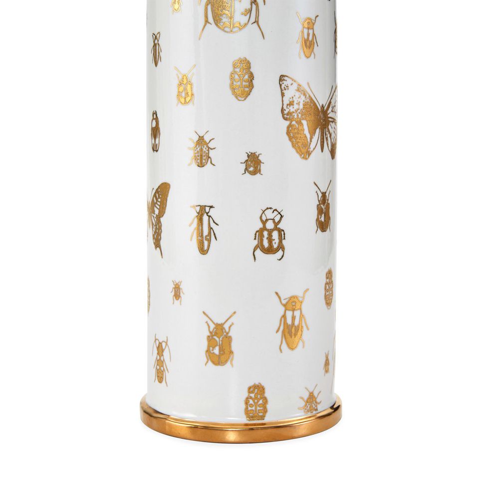 A stylish white and gold table lamps with bug details