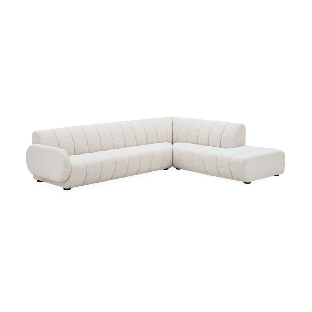 A glamorous left arm facing sectional sofa with an Olympus Ivory bouclé upholstery, deep channelled cushions and capsule-shaped arms