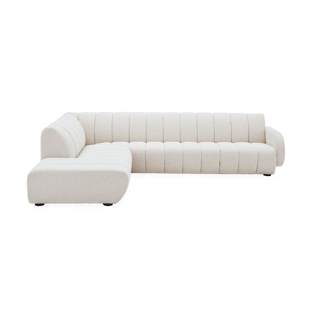 A glamorous left arm facing sectional sofa with an Olympus Ivory bouclé upholstery, deep channelled cushions and capsule-shaped arms