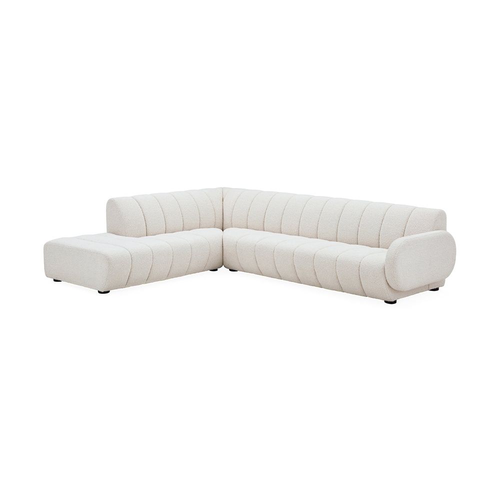 A sumptuous sectional sofa by Jonathan Adler upholstered in an Olympus Ivory bouclé with stylish deep channelled cushions and capsule-shaped arms