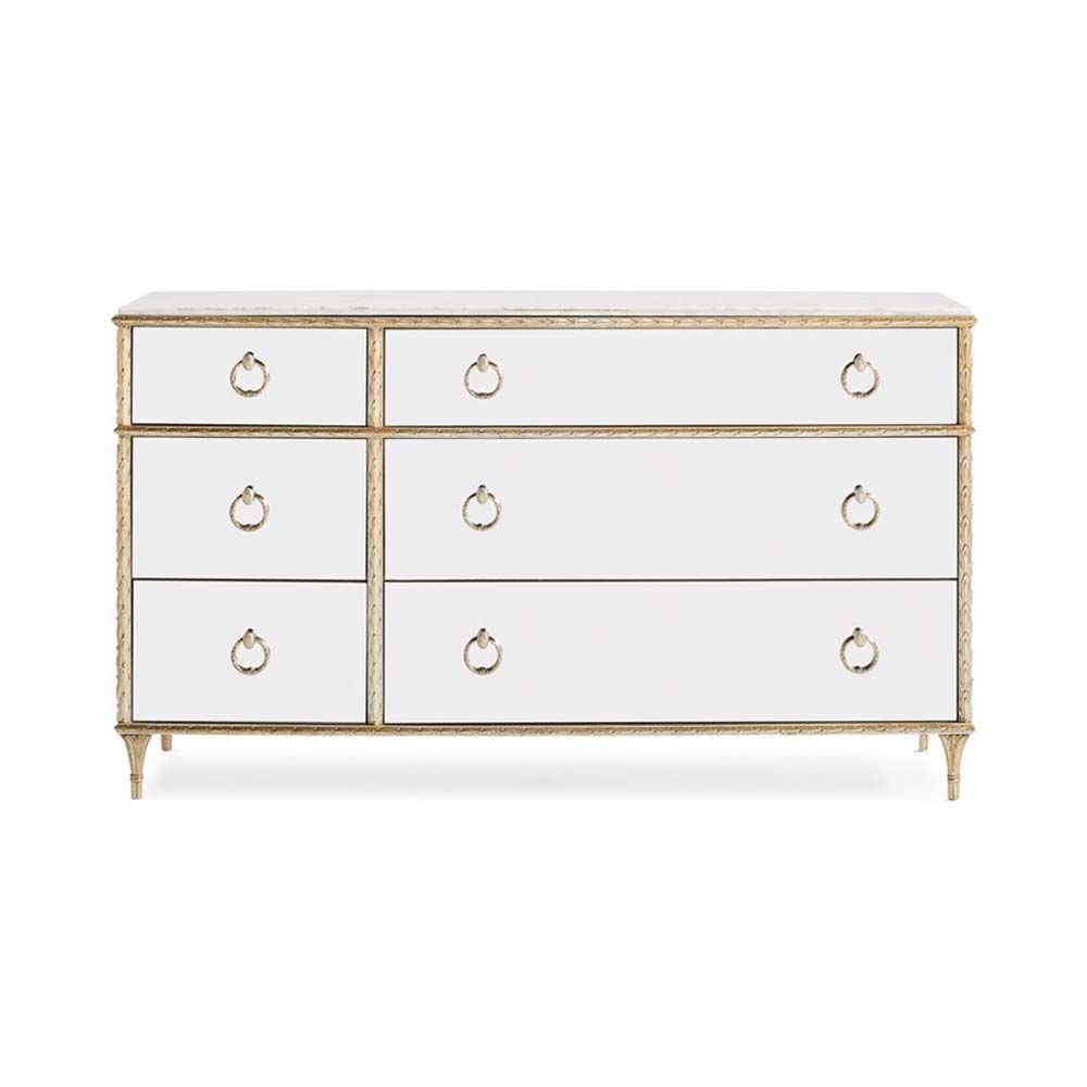 A luxurious mirrored dresser/chest of drawers with antique detailing and a champagne finish