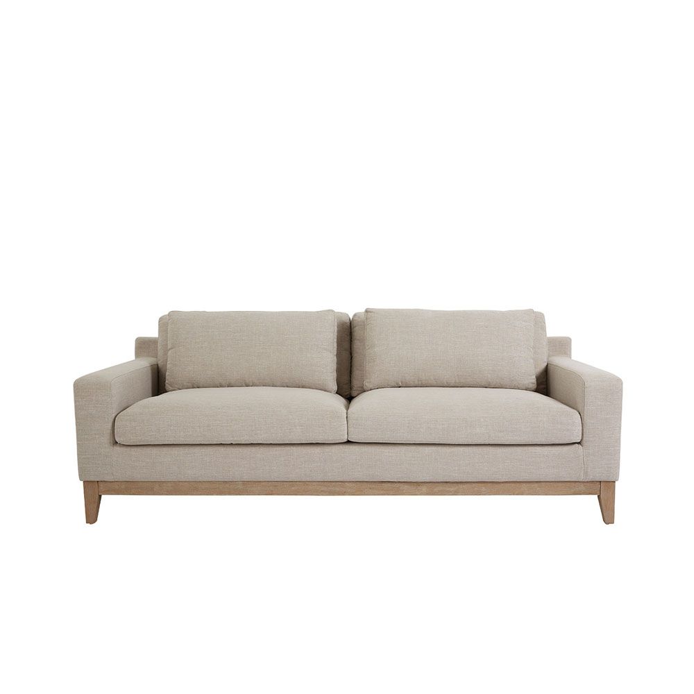 A luxurious modern cosy sofa with beige upholstery  