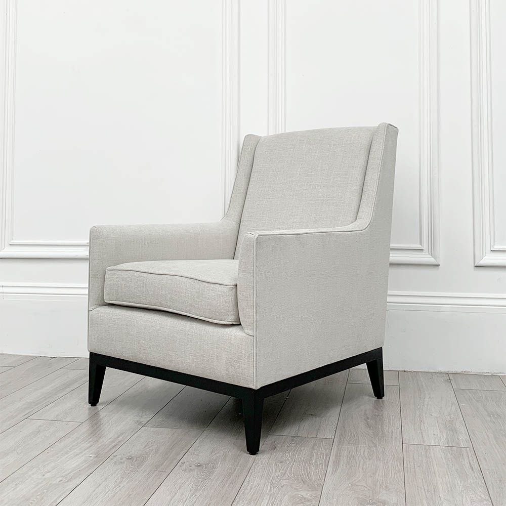 A gorgeous armchair with a wooden base and mid-century undertones