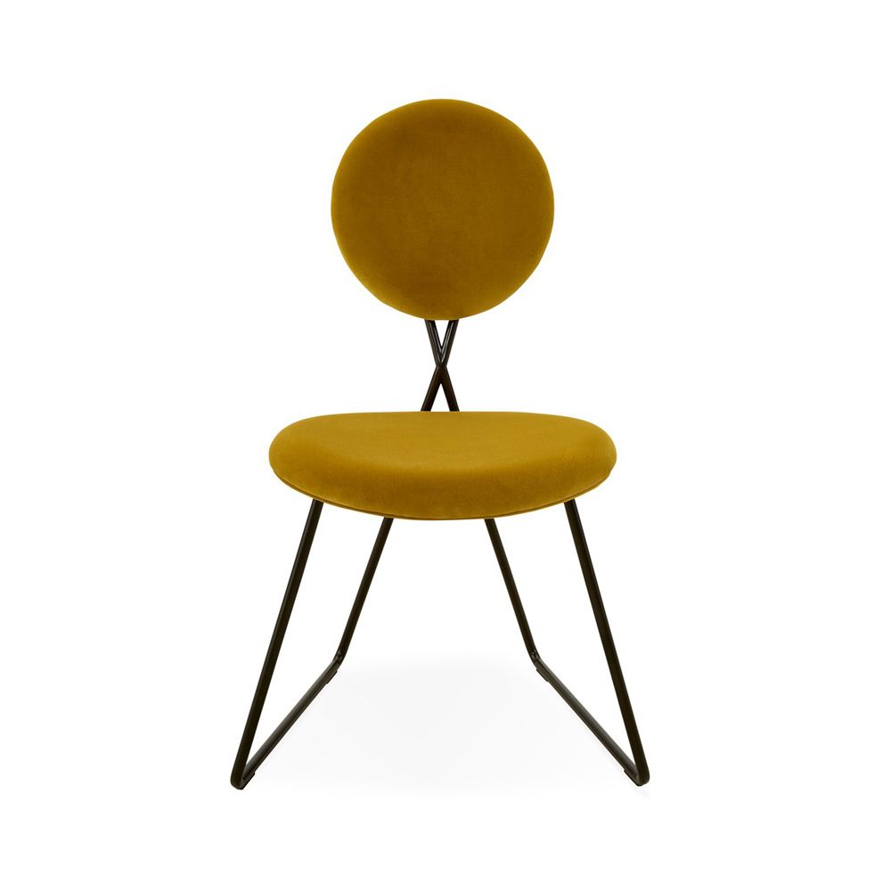 A rich yellow velvet dining chair with a blackened steel frame 