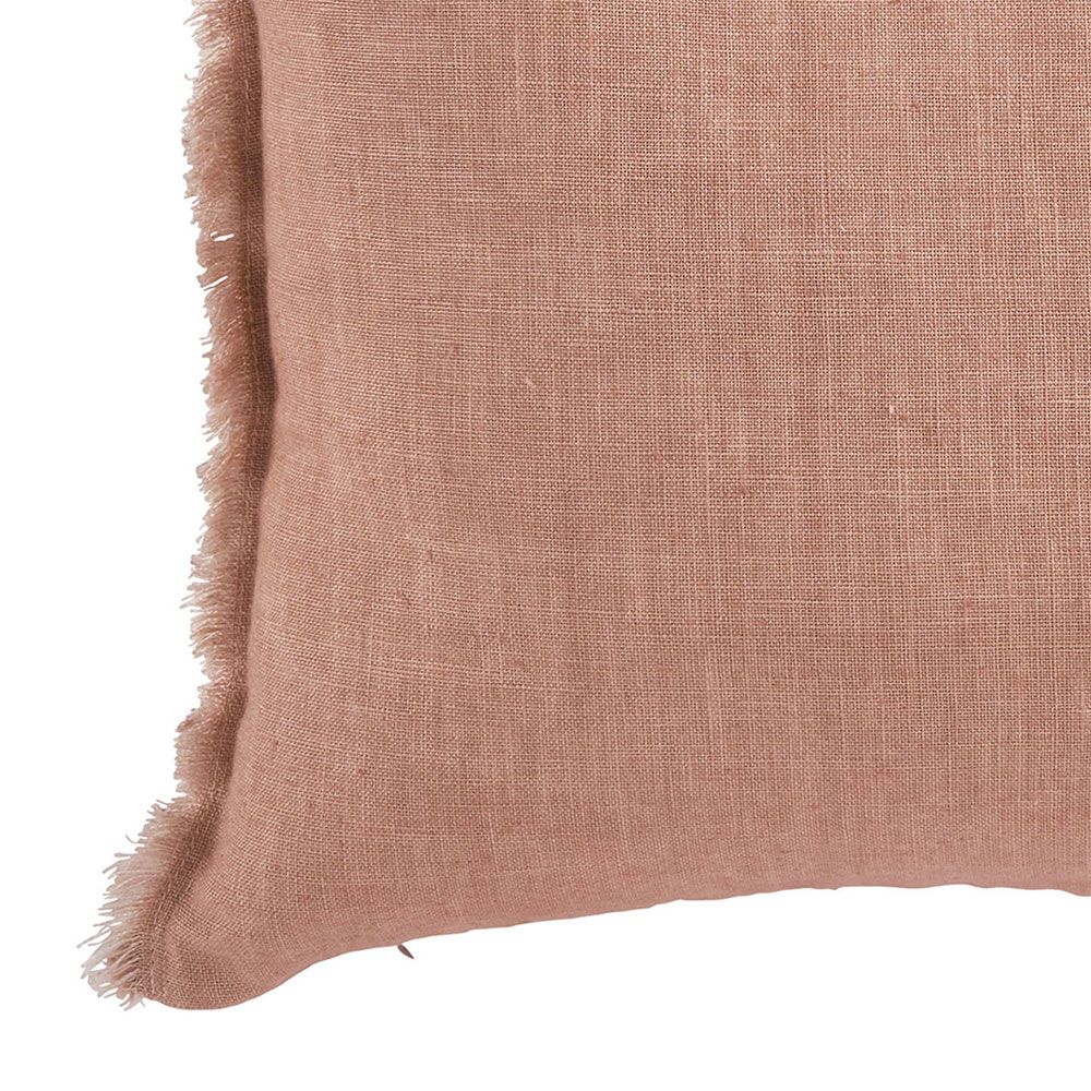 delightful blush cushion with a fringed border