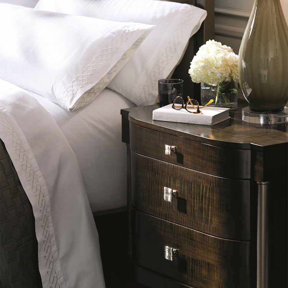 Decadent bedside table with bronze accents and dark brown finish