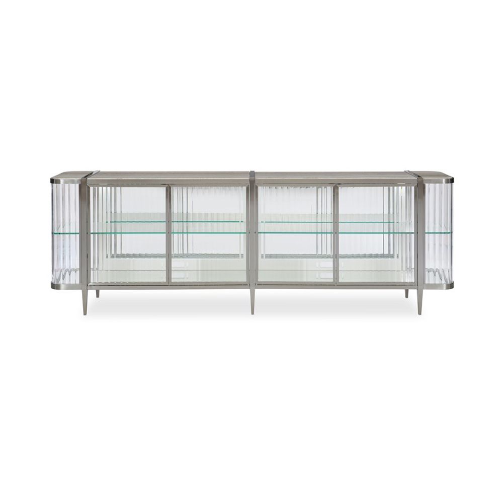 A contemporary console table by Caracole with clear, wave-effect acrylic doors and a mirrored interior