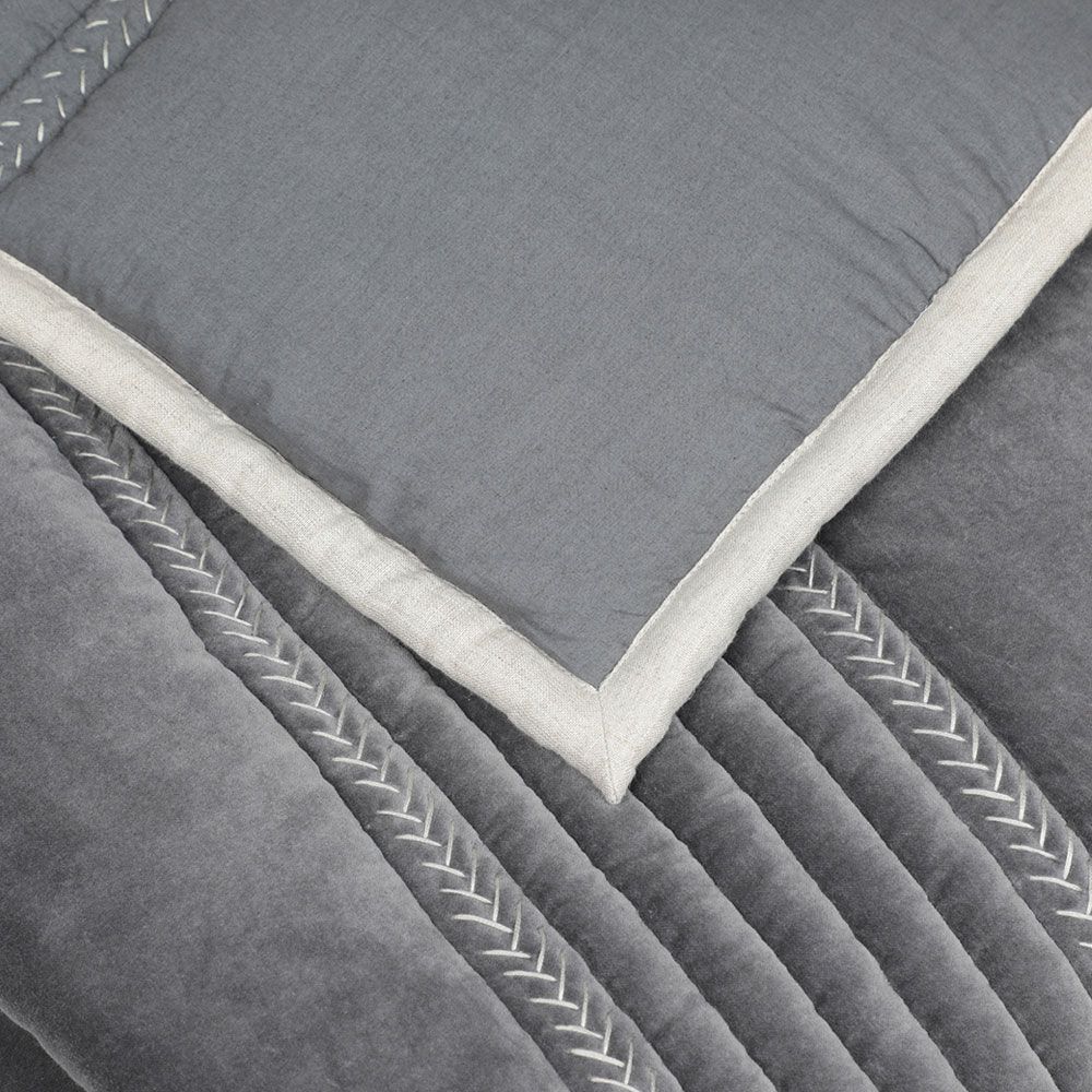 A luxurious grey quilt with handstitched details