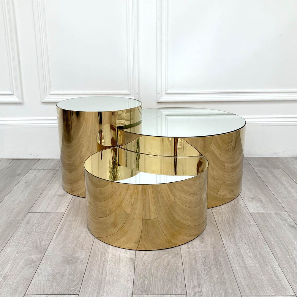 Glamorous set of three tables with mirrored tops and polished brass bases