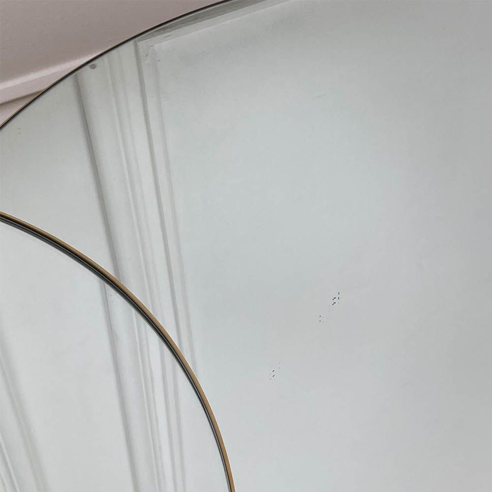 Black specks on surface of round table