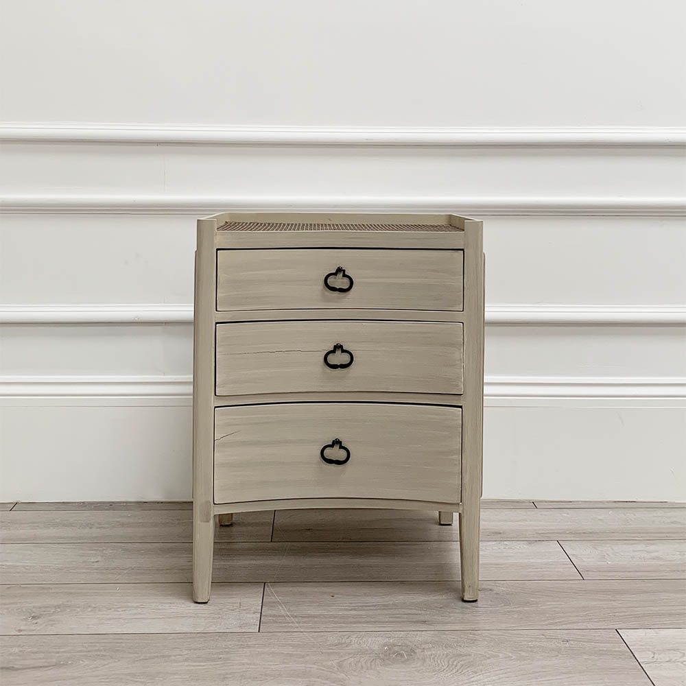 White washed three door bedside cabinet with some splits to the wood. 