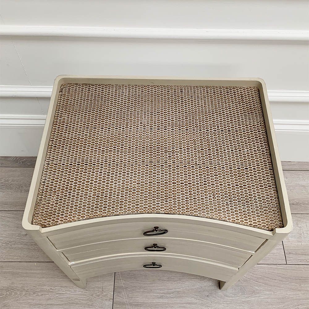 White washed three door bedside cabinet with some splits to the wood. 