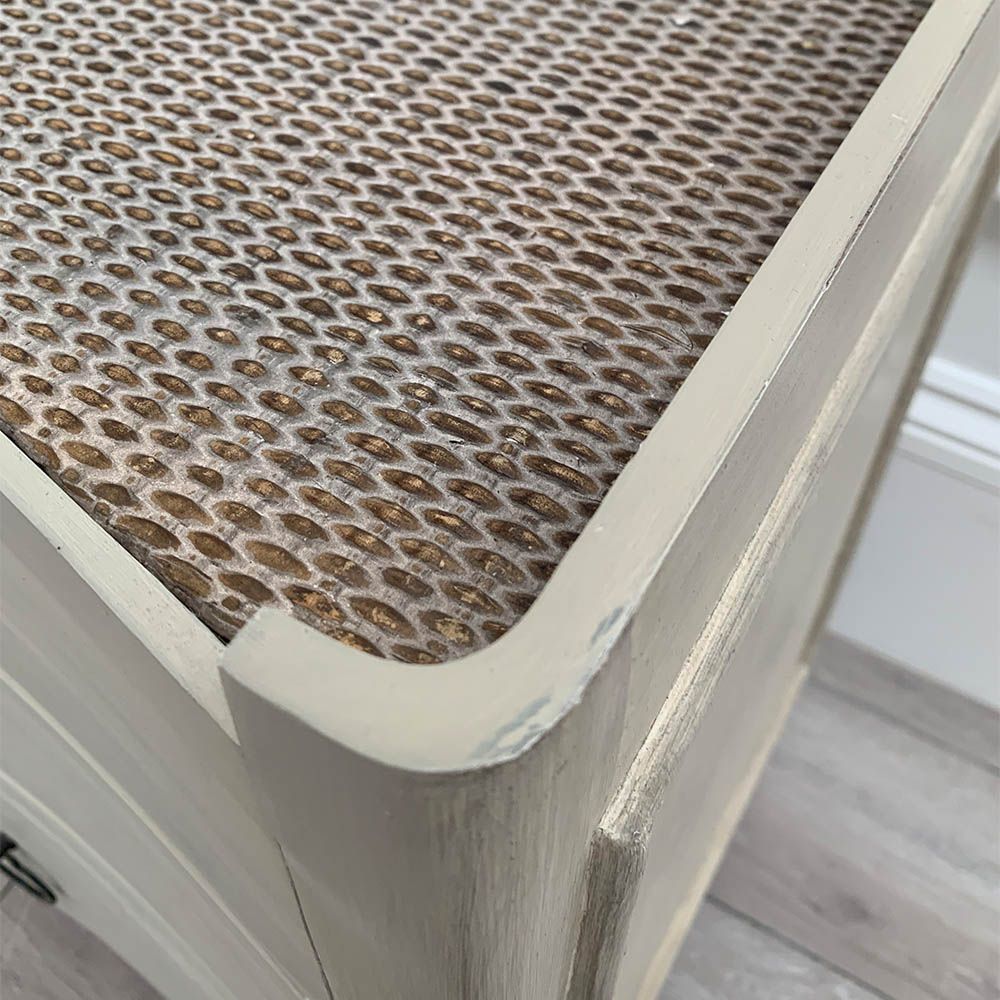 White washed three door bedside cabinet with some splits to the wood. 