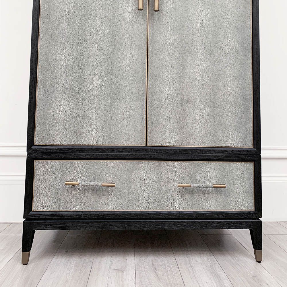 A luxurious grey shagreen wardrobe with antique brass and black detailing 