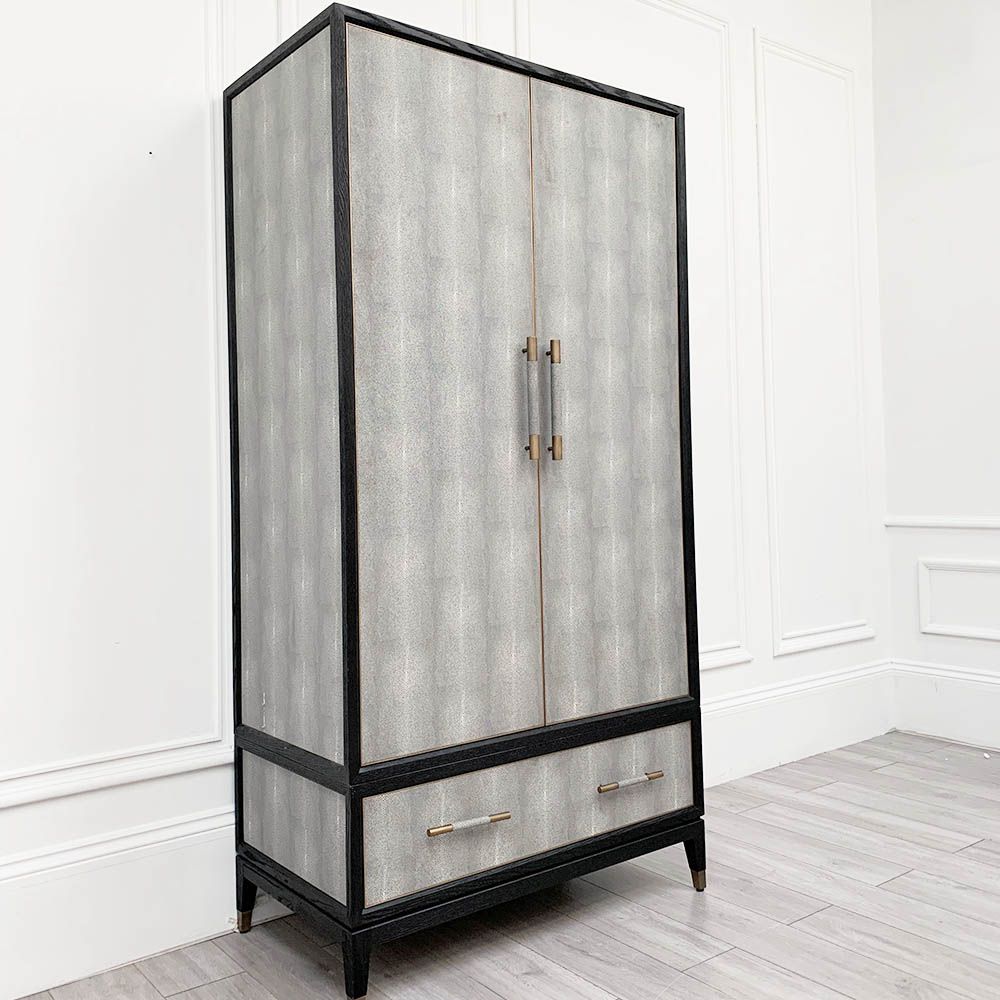 A luxurious grey shagreen wardrobe with antique brass and black detailing 