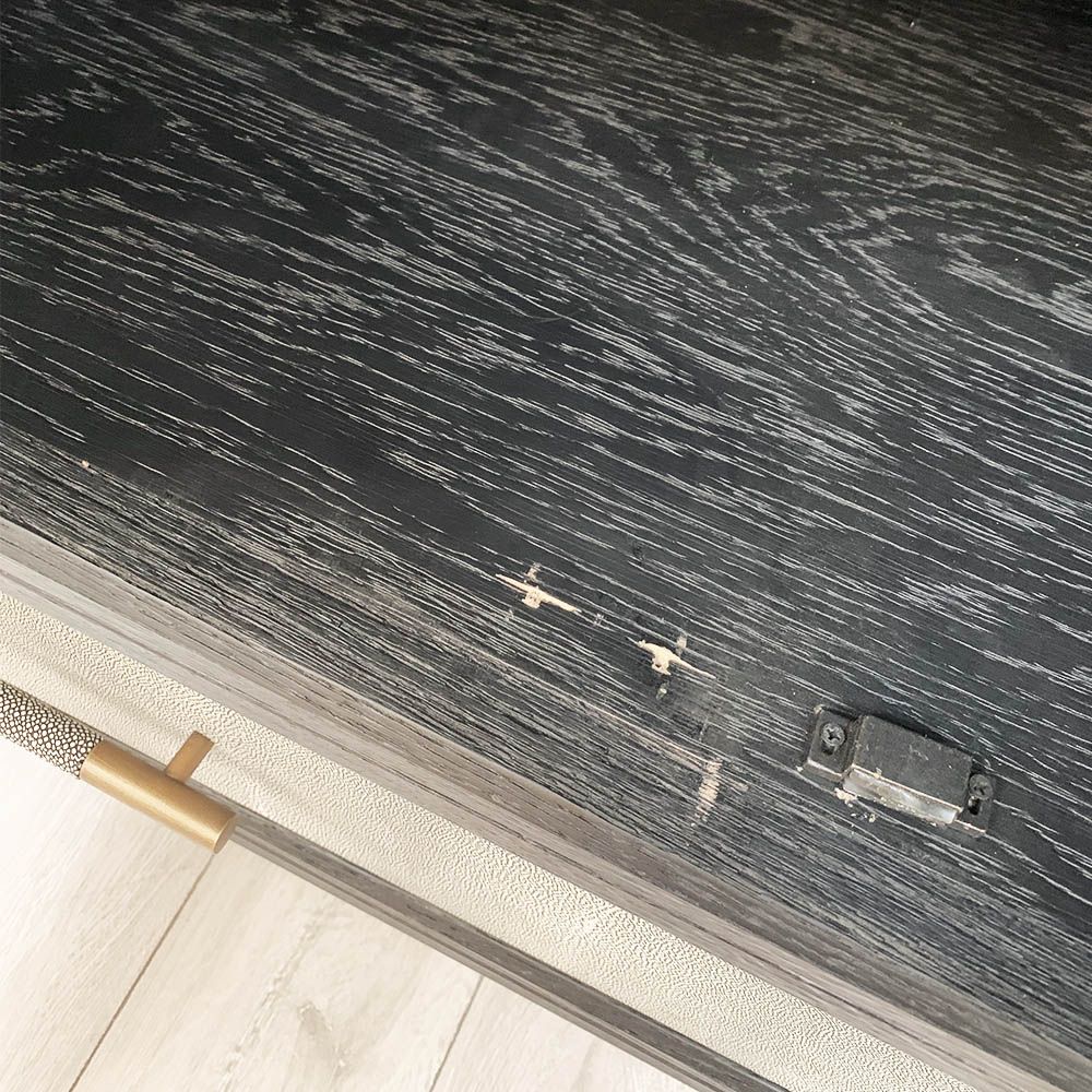 A luxurious grey shagreen wardrobe with antique brass and black detailing 