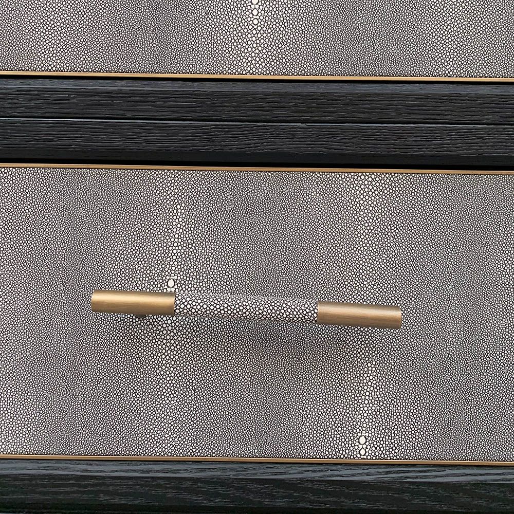 A luxurious grey shagreen wardrobe with antique brass and black detailing 