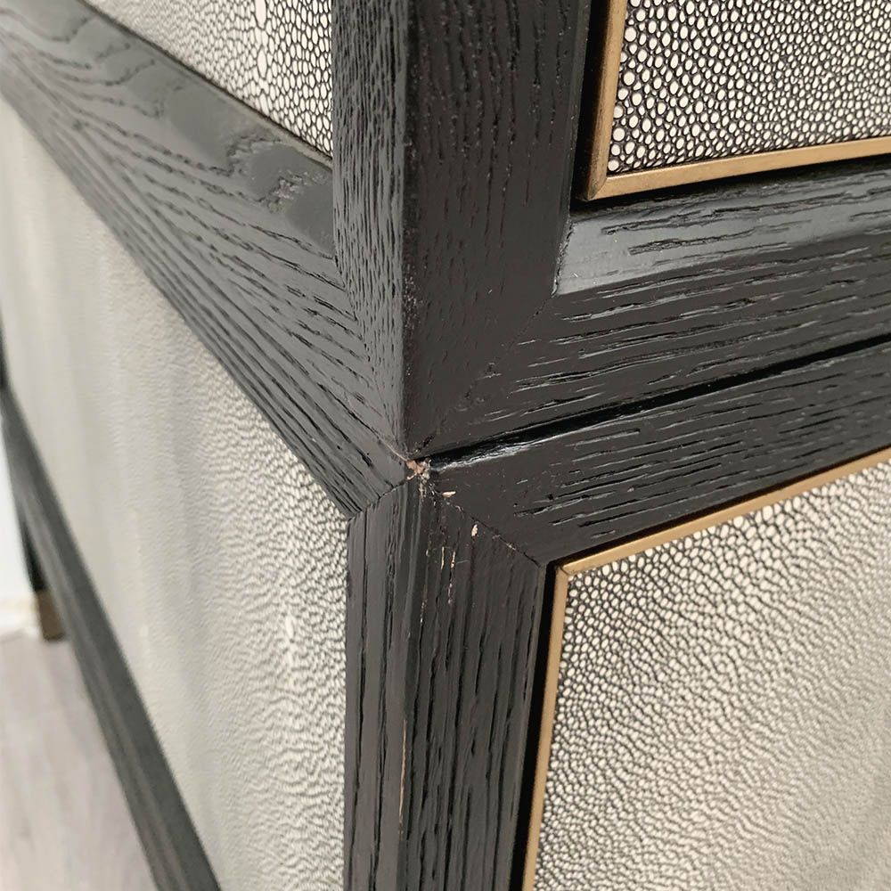 A luxurious grey shagreen wardrobe with antique brass and black detailing 