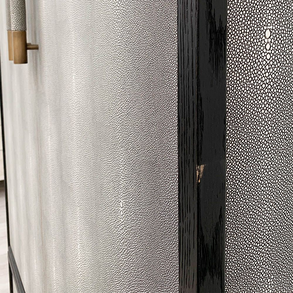 A luxurious grey shagreen wardrobe with antique brass and black detailing 