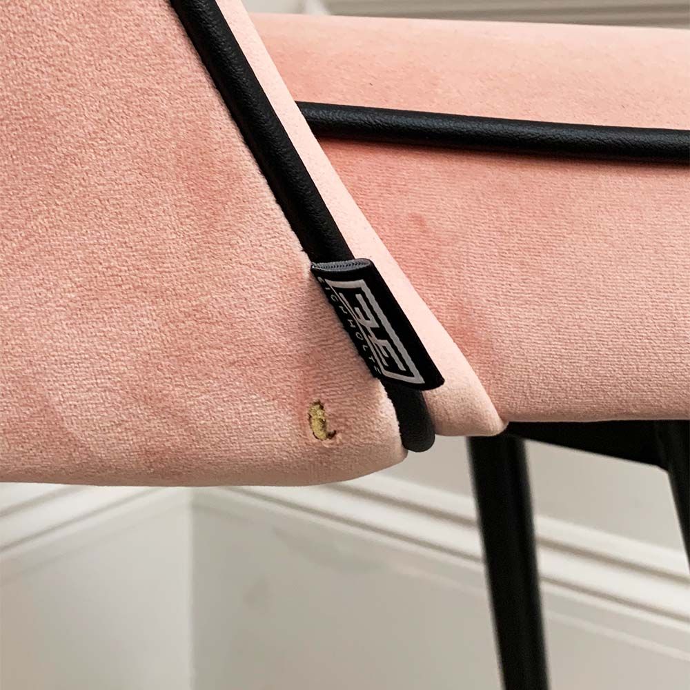A pair of pink velvet mid-century counter stool with black faux leather piping and golden feet caps