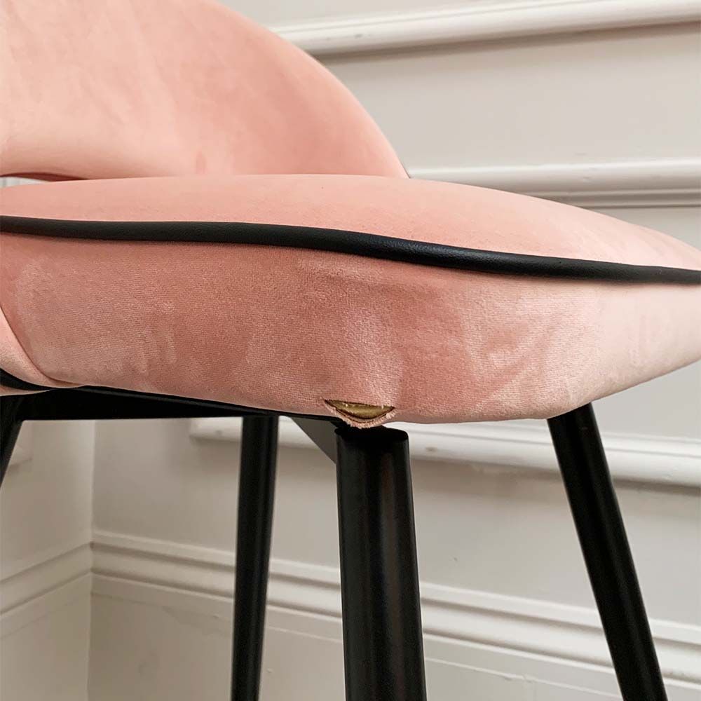 A pair of pink velvet mid-century counter stool with black faux leather piping and golden feet caps