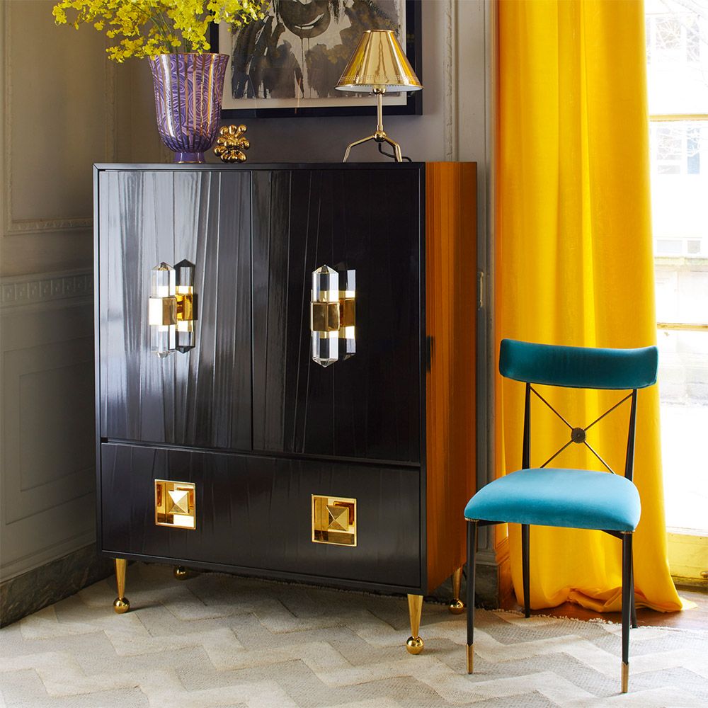 A luxurious, contemporary cabinet with glossy black lacquer and acrylic and brass accents 