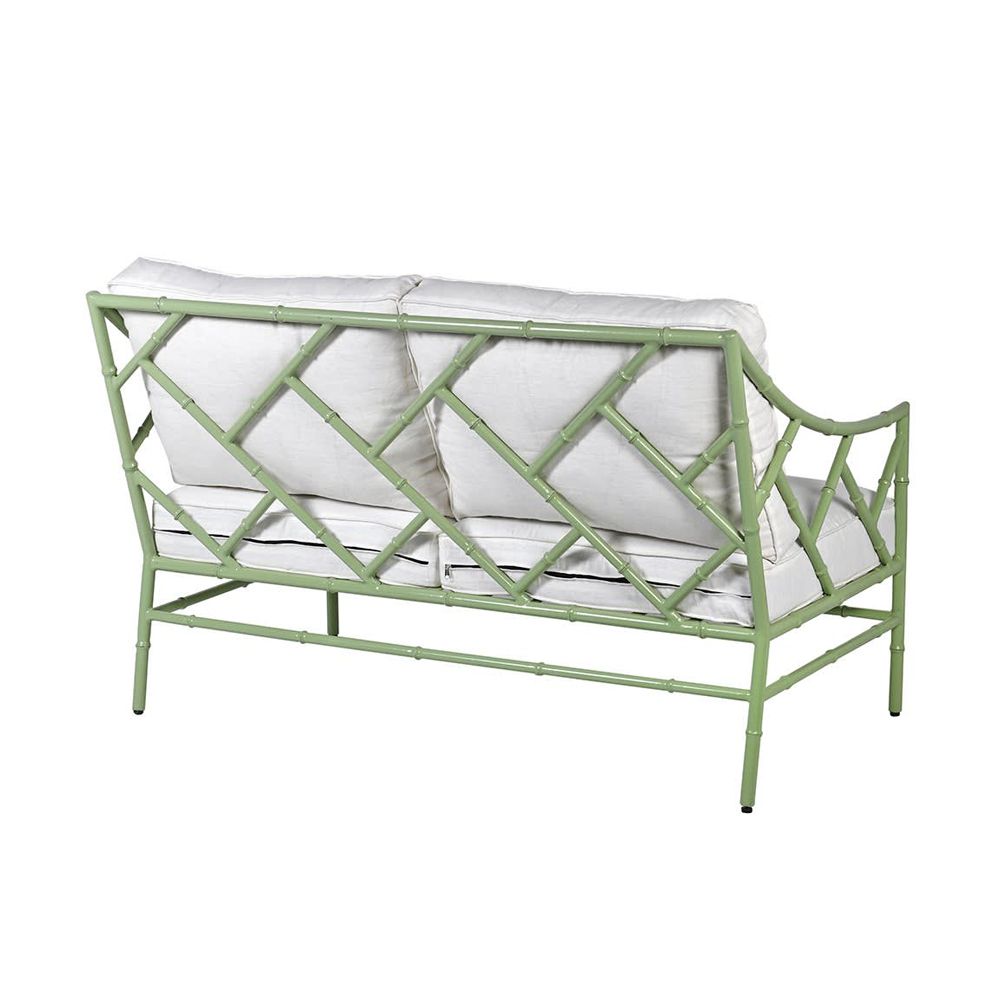 A stylish sage green outdoor two seater sofa with white cushions