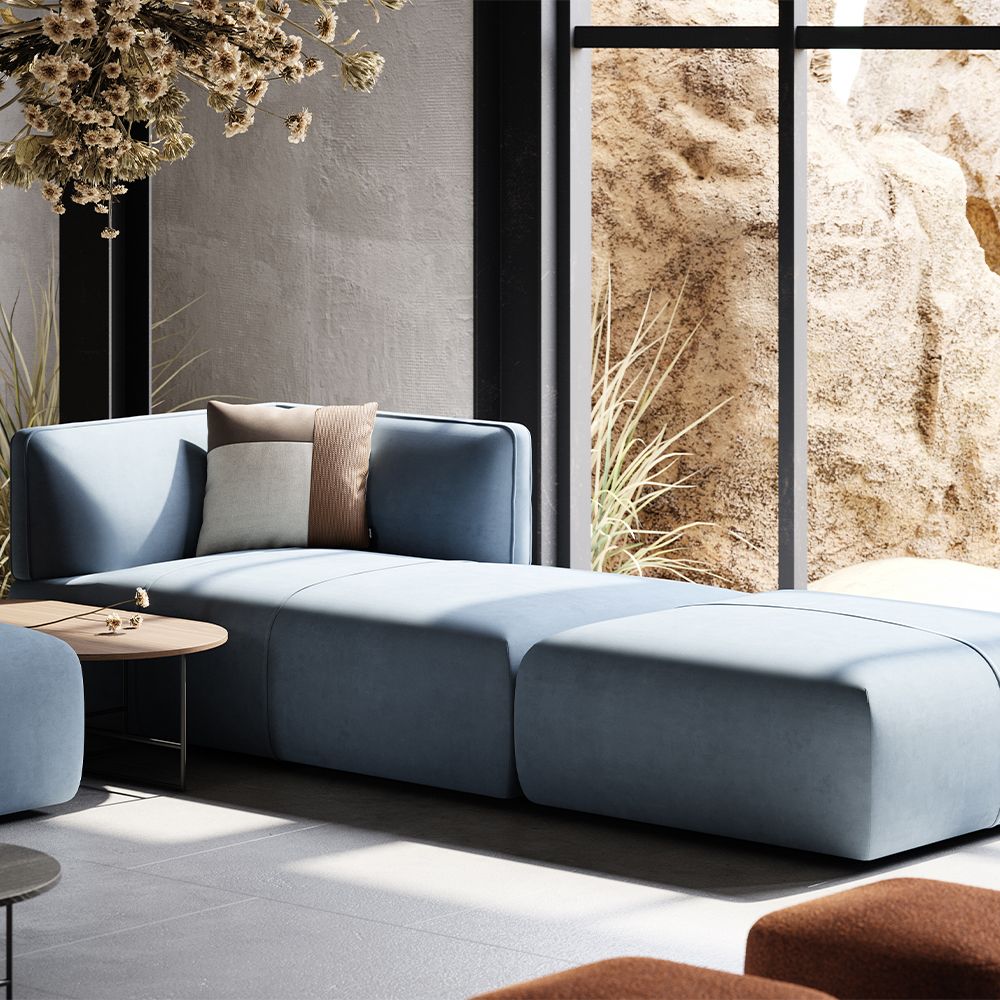 Luxury, large sofa upholstered in a beautiful blue fabric, with curvy, contemporary design