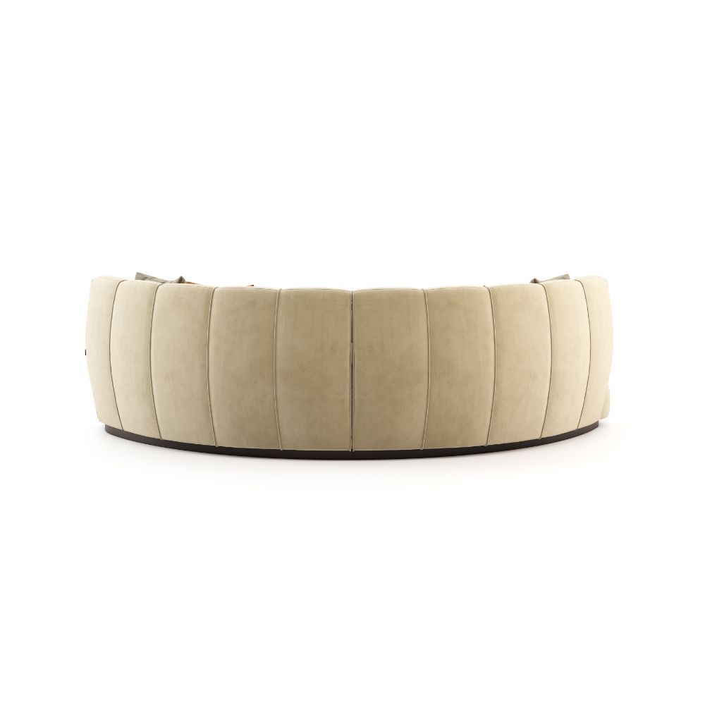 A luxurious beige velvet curved, contemporary design sofa 