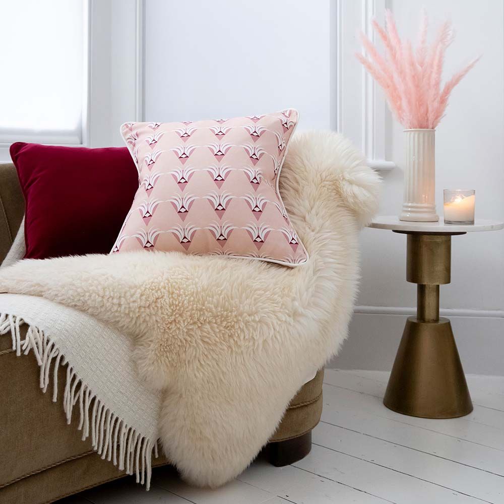 A gorgeous, art deco inspired cushion with multiple shades of pink and white