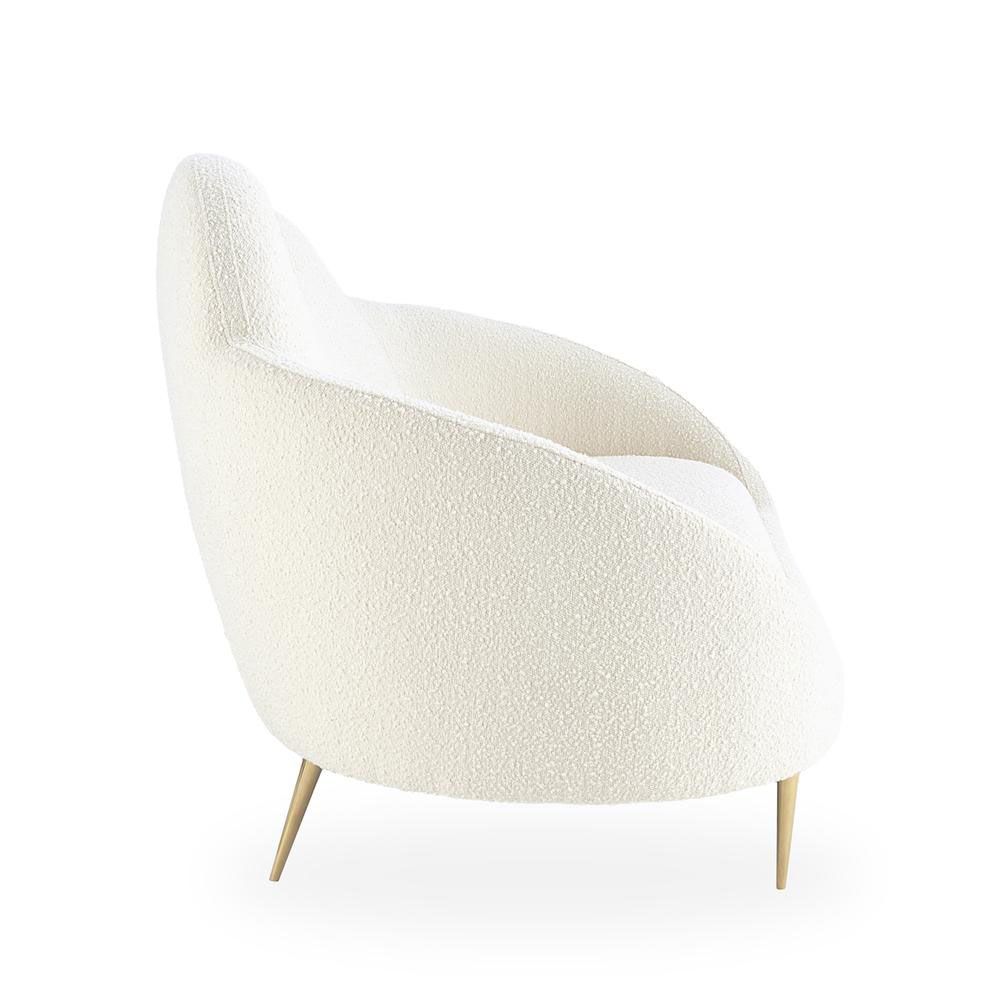 A luxurious cloud-shaped sofa with boucle upholstery and polished brass legs
