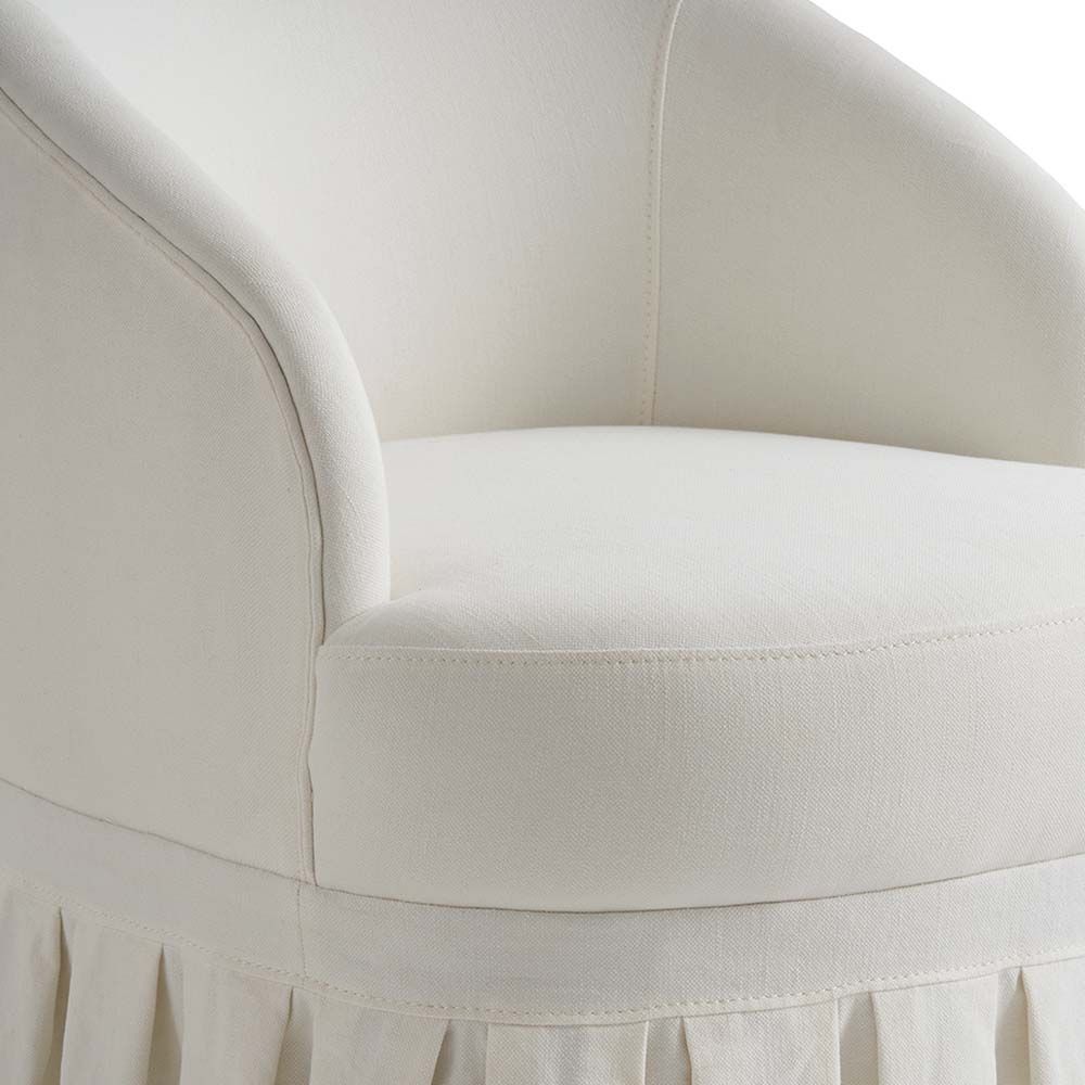 A luxurious, French-style off-white cotton and linen blend armchair with pleated fringing