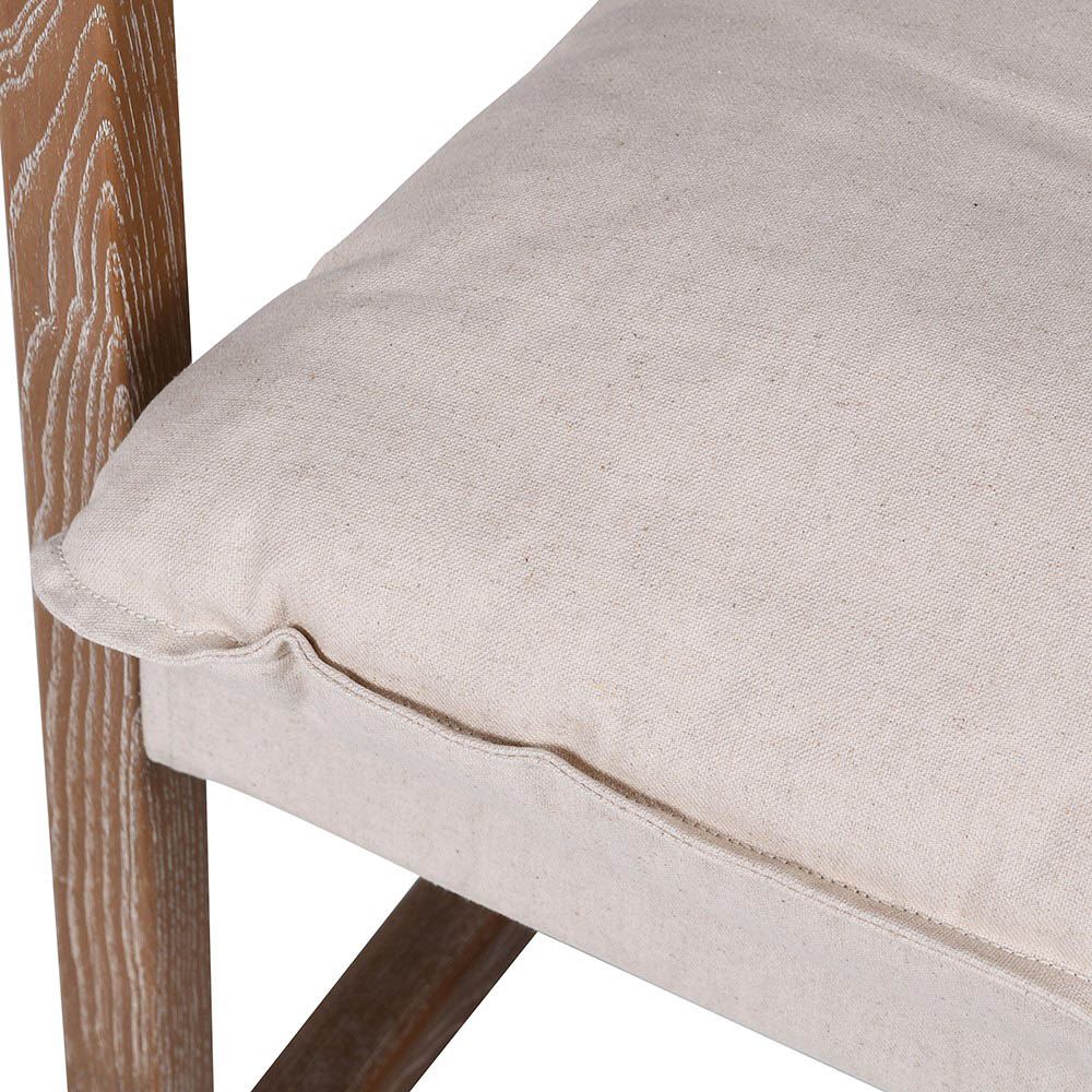 Cosy, neutral armchair with sleek wooden frame and linen seat cushions