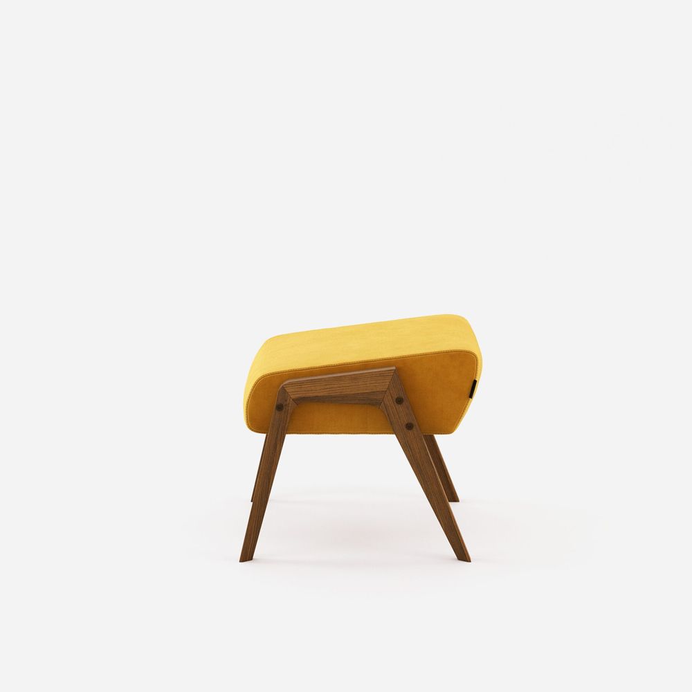 A stylish vibrant velvet ottoman with walnut wood legs 